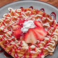 Strawberry Cheesecake · Strawberry cheesecake, strawberry sauce, whipped cream & powdered sugar..