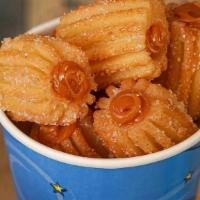 Churrobites 3X2 - Buy Two Get One Free! · Delicious churro bites covered in sugar and filled with your favorite topping. 22 oz cup.
