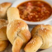 Garlic Knots (12) · House baked rolls lightly topped with garlic oil, parmesan cheese and served with our marina...