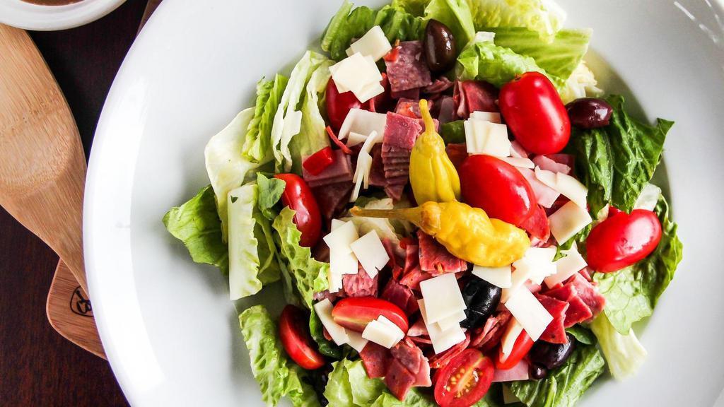 Antipasto Salad · Fresh greens with ham, salami, cappicolla, provolone cheese and tomatoes.  Tossed in our house vinaigrette. Topped with roasted red peppers and kalamata olives.