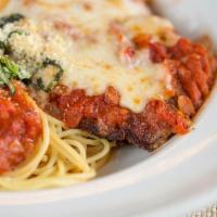 Chicken Parmigiana · Lightly breaded chicken breast topped with mozzarella cheese and baked in our marinara sauce...