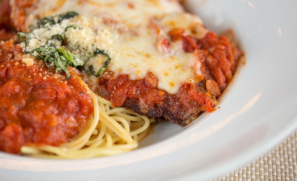 Chicken Parmigiana · Lightly breaded chicken breast topped with mozzarella cheese and baked in our marinara sauce.  Served with a side of pasta.