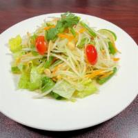 Papaya Salad · Papaya, carrot, tomato, green beans and peanut in Thai Style salad seasoning.