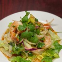 Jumping Shrimp Salad · Thai traditional salad with shrimp, onion, red onion, scallion, cucumber, lime juice chili p...