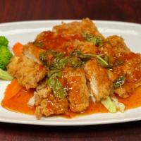 Volcano Chicken · Fried chicken breast in Thai chili sauce and basil served on top of steam  vegetables.