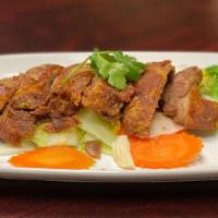 Crispy Duck Chili · Crispy duck in Thai chili sauce and basil served on top of steam vegetables (carrot, broccol...