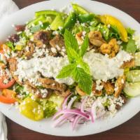 Combo Salad · A combination of chicken and gyro meat on a Greek salad topped with our homemade tzatziki sa...