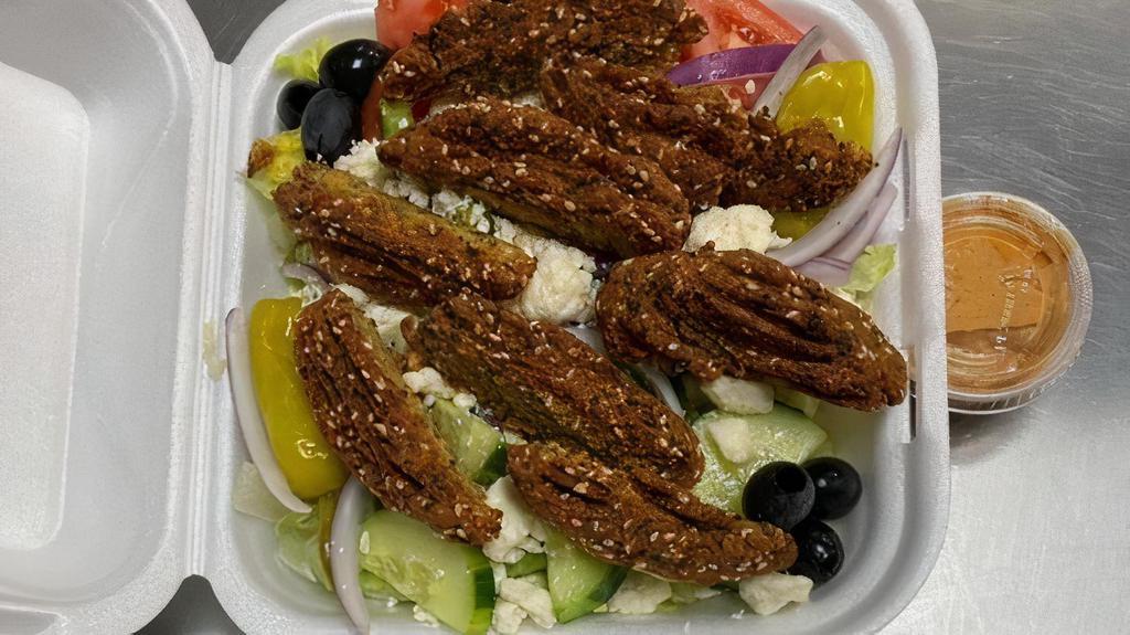 Falafel Platter · Vegetarian patties, made with chickpeas and herbs. Topped with hummus, tzatziki sauce, and feta cheese. Served with side Greek salad, homemade Greek potatoes, and pita bread.