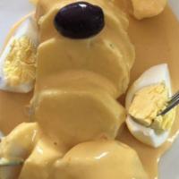 Potatoes In Huancaina Sauce · Traditional Peruvian potatoes, covered in andean cheese cream with yellow peppers.