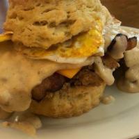 The Cowboy · Our flaky biscuit with country fried steak, pecanwood bacon and a fried egg, topped with che...
