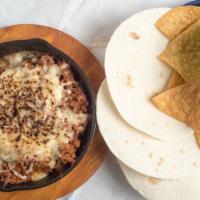 Queso Flameado · Melted cheese, your choice of Mexican sausage or grilled steak. Served with flour tortilla.