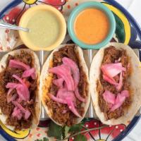 Tacos De Carnitas · Three tacos filled with well-seasoned pork served with corn or flour tortillas.