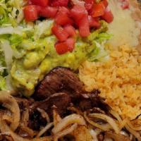 Carne Asada · Well-seasoned grilled skirt steak topped with grilled onions. Served with rice, beans, salad...