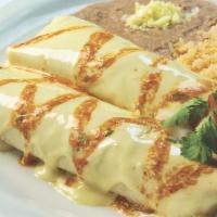 Burrito De La Roqueta · Medium spicy. Two pork burritos smothered with hot tomatillo sauce, pico de gallo and our sp...