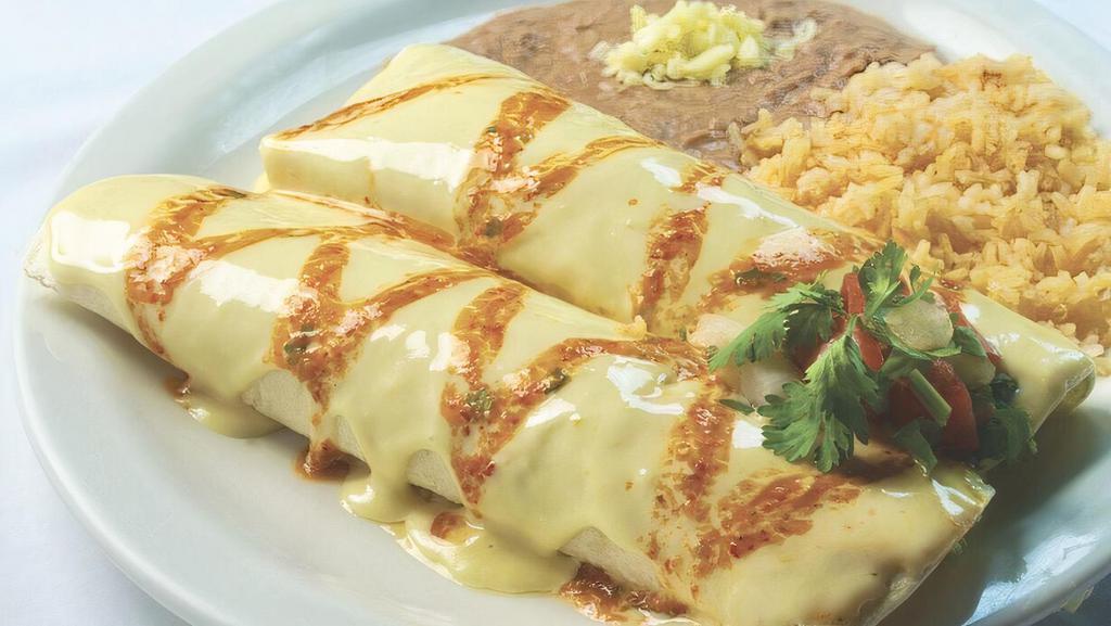 Burrito De La Roqueta · Medium spicy. Two pork burritos smothered with hot tomatillo sauce, pico de gallo and our special cheese sauce. Served with rice and beans.