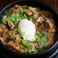 Sukiyaki Udon · White thick noodle broth with sukiyaki beef, egg & vegetables in the hot pot.