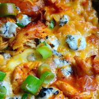 Buffalo Mac And Cheese · Baked Mac and cheese topped with crispy chicken, Buffalo sauce, ranch sauce, scallions and b...