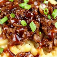 Big Meaty Bbq Mac And Cheese · Baked Mac and cheese topped with pulled pork, ground beef, shredded chicken and drizzled wit...