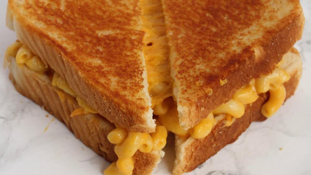 Classic Mac Grilled Cheese · Mac & Cheese and additional cheddar slices stuffed between two slices of buttered bread and grilled to perfection.