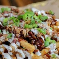 Bbq Trio Fries · Fries loaded with shredded cheeses, bbq sauce, ranch, pulled pork, chopped steak and chopped...