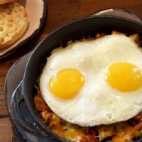 Ultimate Skillet · Harbor potatoes, ham, mushroom, green pepper, onion, tomato and Jack & Cheddar cheeses, topp...