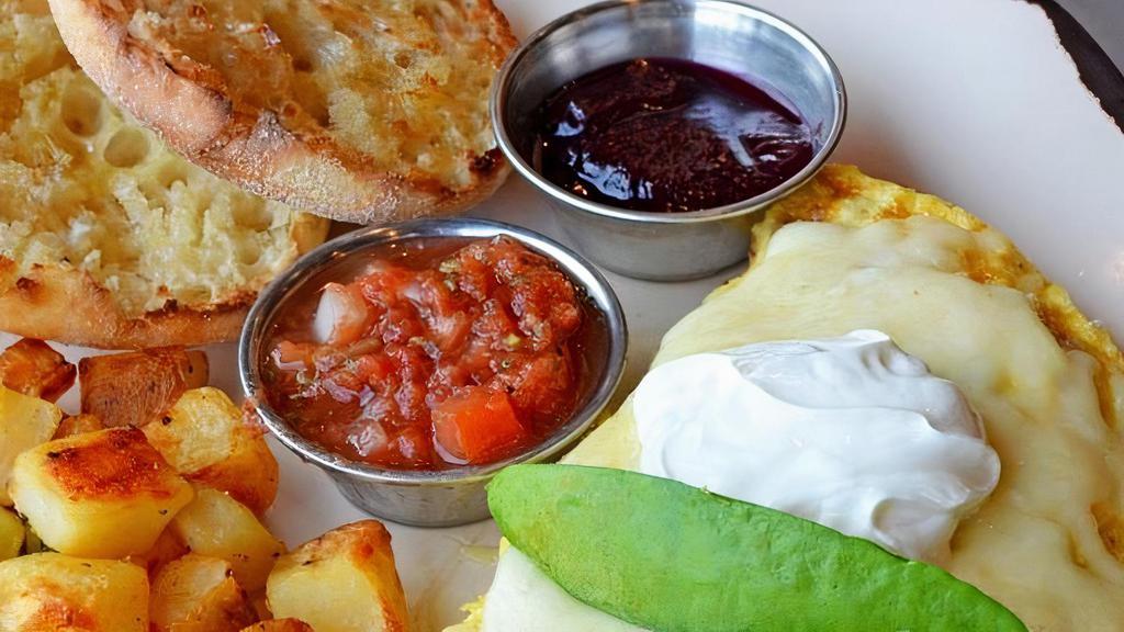 Bacado Omelette · Bacon and avocado folded into three cage free eggs, topped with Jack cheese, sour cream and green onions. Served with salsa made in house, Harbor potatoes and a buttered English muffin with house-made jam.