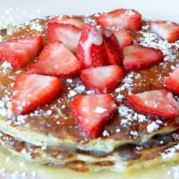 Lemon Poppyseed Pancakes · Topped with fresh strawberries, lemon icing and powdered sugar. Make it a combo with a small...