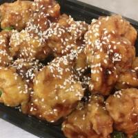 Sesame Chicken · Served with chicken fried rice and shrimp roll. Served spicy.