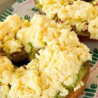 Avocado Toast With Egg · One whole wheat bagel sliced in half, toasted. With Creamy chunky avocado and buttery scramb...