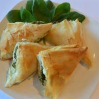 Spanakopita Appetizer · phyllo triangles stuffed with chopped spinach, onions, ricotta and feta cheese. Served with ...