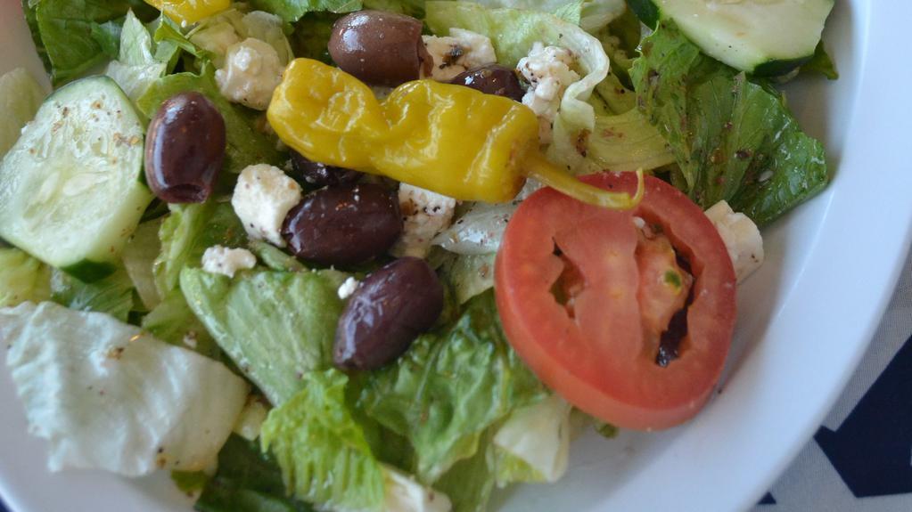 Greek Salad · Fresh mixture of lettuce, tomatoes, cucumbers, Greek peppers, Kalamata olives and crumbly feta cheese tossed in our Greek vinaigrette. Served with homemade tzatziki sauce and pita bread.