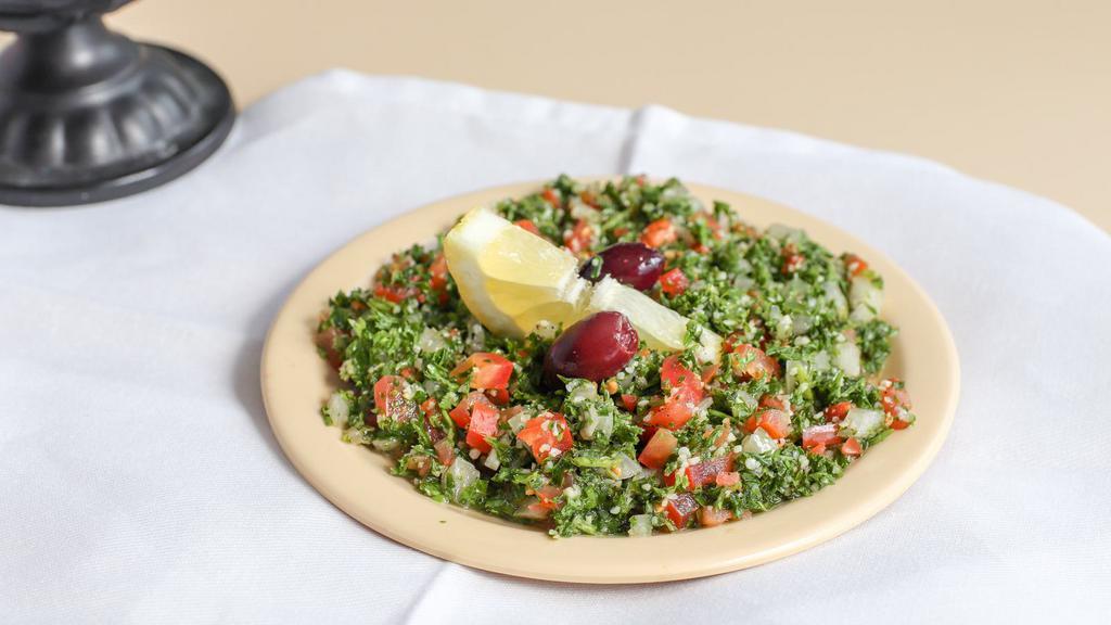 Tabouleh Salad · Healthy vegetarian salad traditionally made of bulgur (cracked wheat), diced tomatoes, parsley, mint and onion and seasoned with olive oil, lemon juice and salt.