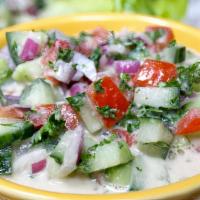 Jeruslem Salad · Mixture of diced tomatoes, cucumbers and herbs with tahini dressing
