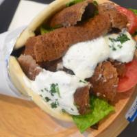 Gyro Wrap · Seasoned thin slices of beef and lamb. Served on warm pita bread with lettuce, tomatoes and ...