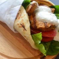Grilled Chicken Wrap · Tender marinated chicken breast charbroiled to perfection. Served on warm pita bread with le...
