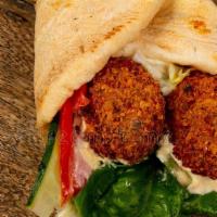 Vegetarian Falafel Wrap · Deep fried chickpea patties seasoned with a blend of spices served in a heated pita with hum...