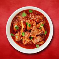 Country Side Lamb Curry · Pieces of lamb sauteed with fresh garlic, ginger, and tomatoes.