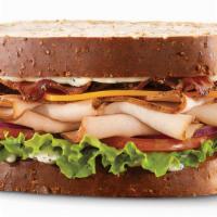 Turkey Club Sandwich · Multi grain with turkey, mayo, tomato, lettuce, cheese and bacon.