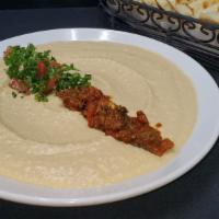 Hummus · Mashed chick peas, mixed with fresh lemon juice, minced garlic olive oil and tahini. Served ...