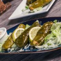 Dolma (Stuffed Grape Leaves) · Grape leaves stuffed with rice, spices, parsley, mint and raisins.