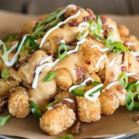 Loaded Taters · Beer - Infused. Tater tots loaded with our amber ale beer cheese & topped with fresh jalapeñ...