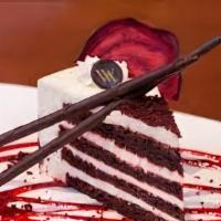 Red Velvet Cake · Red velvet cake with frosted cream on top and a condesed milk syringe.