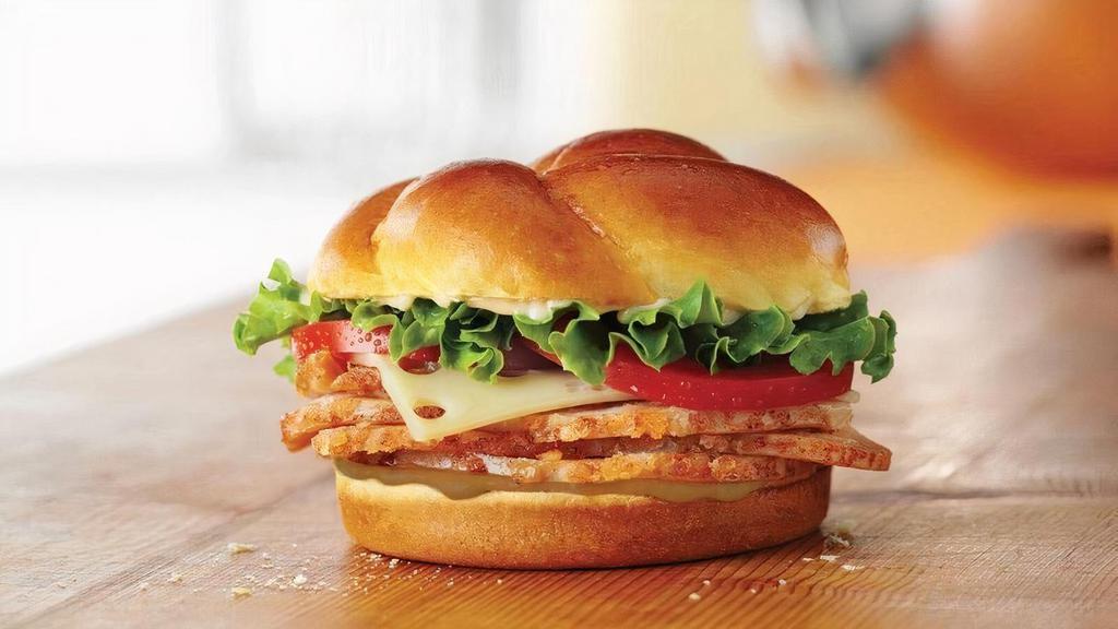 Roasted Turkey Classic Sandwich · Roasted Honey Baked Turkey Breast topped with Swiss cheese, lettuce, tomato, Duke’s® mayonnaise, and hickory honey mustard on a baker’s roll.