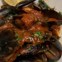 Mussels De La Nonna · Steamed mussels prepared in a garlic white wine or marinara. Served with foccacia.