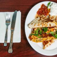 Chicken Quesadilla · Cheese quesadilla with grilled chicken, tomatoes, onion and peppers. Served with sour cream ...