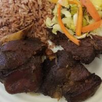 Jerk Pork · Served with rice and peas or white rice, plantain, and veggies.