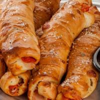 Pepperoni Rolls · Pepperoni and mozzarella cheese wrapped in fresh pizza dough and baked. Topped with garlic b...