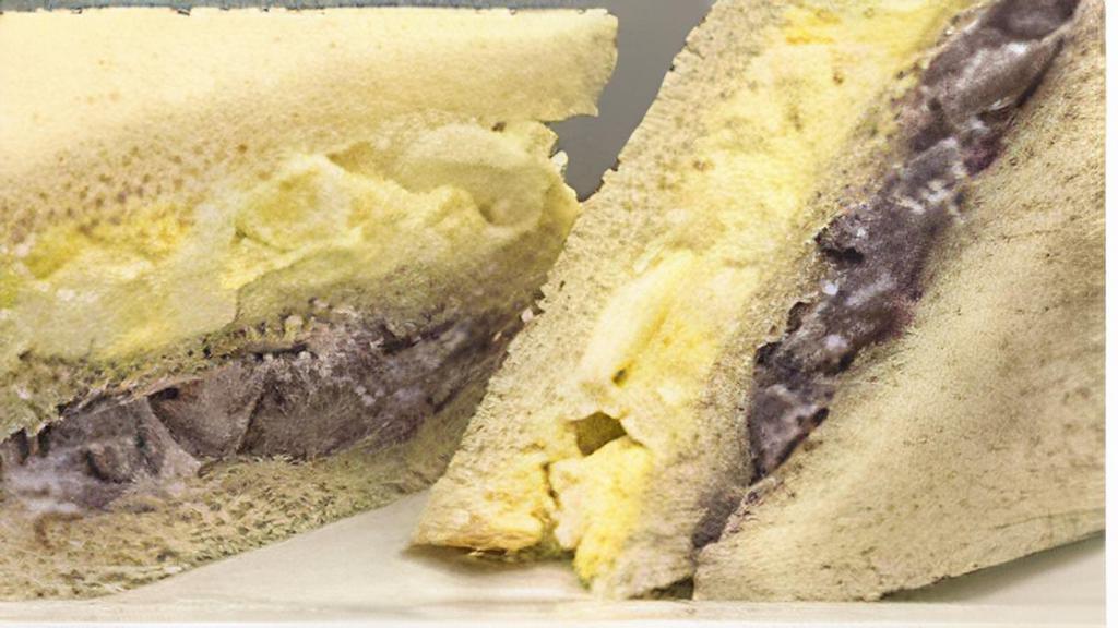 Triple De Aceituna Sandwich · Peruvian black olives with pecans and raisins. Hard egg with mayonnaise in white bread.