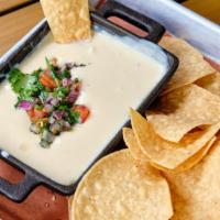 Queso Dip & Chips · Creamy cheese dip served with freshly cooked tortilla chips.