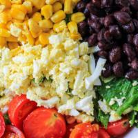 Q Chopped Salad · Chopped romaine lettuce, grilled corn, green onion, black beans, a chopped egg, and cherry t...